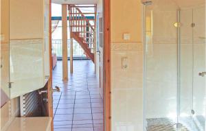 a bathroom with a walkin shower and a staircase at Cozy Apartment In Börgerende-Rethwisch in Börgerende-Rethwisch +4 photos