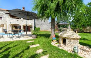 a yard with a tree and an umbrella and a table at Holiday Home Svetvincenat With Outdoor Swimming Pool 207 in Svetvinčenat