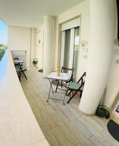 a room with a table and chairs and a window at Alba b&b in Polignano a Mare