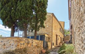 an alley with trees and a stone building at Casa Castelli in Garlenda