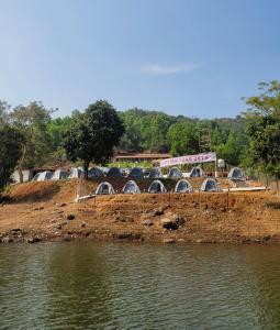 a truck is crossing a bridge over a river at Panshet Lakeside Camping in Pune