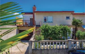 a house with a balcony with a fence at Gorgeous Apartment In Crikvenica in Crikvenica