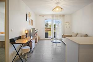 a kitchen and living room with a couch and a table at Appartement Rosalia, cosy & central in Fort-de-France