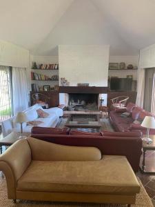 a living room with a couch and a fireplace at Amplia, 4 dormitorios y piscina climatizada in Punta del Este