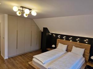 a bedroom with a large bed with lights on the wall at Luna Retreat in Muntele Cacovei
