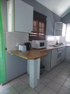 a kitchen with a counter top with a microwave at 27 Pendleberry Grove, Chris Hani Drive, Bela-Bela in Bela-Bela