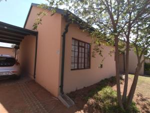 a house with a car parked in front of it at 27 Pendleberry Grove, Chris Hani Drive, Bela-Bela in Bela-Bela