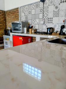 a kitchen with a white counter top and a sink at FLAMENCOS Apart in Esquel