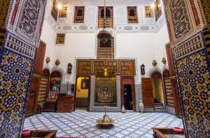 a view of a room with a building with a mosque at Riad Ibn Khaldoun in Fès