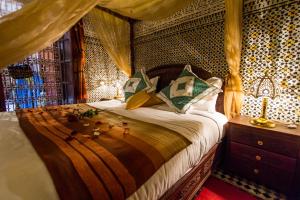 Postel nebo postele na pokoji v ubytování Riad Ibn Khaldoun