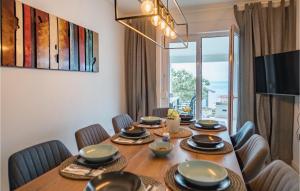 a dining room with a table and chairs and a large window at Villa Miracle in Split