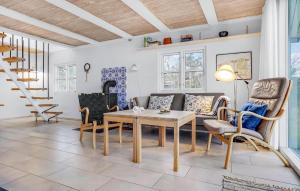 a living room with a couch and a table and chairs at Cozy Home In Glesborg With Kitchen in Glesborg