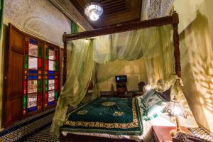 Postel nebo postele na pokoji v ubytování Riad Ibn Khaldoun