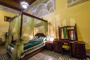 Postel nebo postele na pokoji v ubytování Riad Ibn Khaldoun