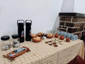 a table with jars and other items on it at La Casona del Norte Jujuy in San Salvador de Jujuy