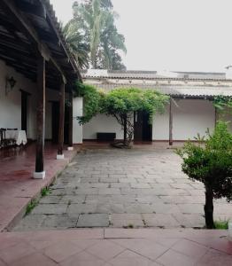 an empty courtyard of a building with trees in it at La Casona del Norte Jujuy in San Salvador de Jujuy