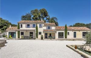 a large white house with a courtyard in front of it at Le Panorama in Roussas