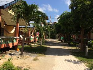 a street in a village with palm trees at Suksabai Resort in Haad Rin