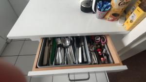 a drawer filled with utensils on a kitchen counter at Single Room In Very Quiet & Cosy House With Garden in Dübendorf