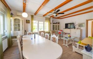 a dining room with a white table and chairs at Holiday Home Skabrnja 79 With Outdoor Swimmingpool in Galovac