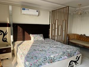 a bedroom with a large bed with a fireplace at stunning studio apartment in Rāmkot