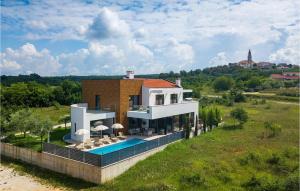 a house with a swimming pool in a field at Villa Aria in Poreč