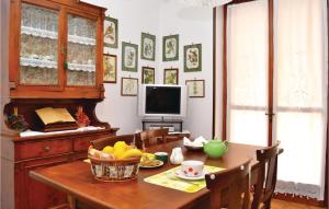 a dining room table with a bowl of fruit and a television at Le Rocche 1 in Cisterna dʼAsti +20 photos