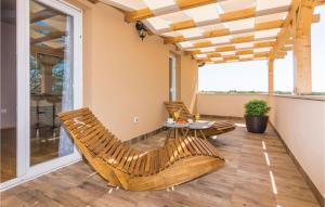 a porch with chairs and a table on a balcony at Six-Bedroom Holiday Home In Galovac in Galovac +54 photos