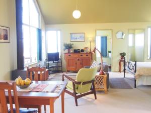 a living room with a table and a dining room at Bundle Hill Cottages in Bawley Point