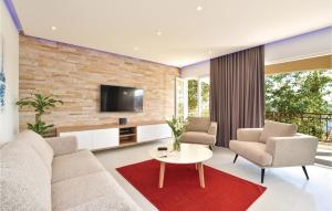 a living room with a couch and chairs and a tv at Amazing Home In Okrug Gornji in Trogir