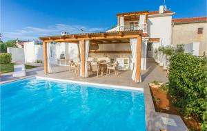 a house with a swimming pool and a pergola at Villa San Biagio Star in Poreč