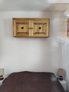 a bedroom with a wooden cabinet above a bed at Résidence Eskival - ESKIVAL APPARTEMENT 35M² 4 PERS CENTRE STATION ACCES DIRECT SUR LES PISTES MAE-7721 in Val Thorens