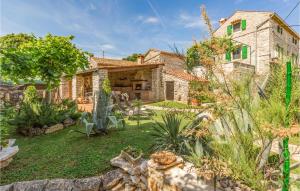 a stone house with a garden in front of it at Casa Luciana Near Rovinj in Kanfanar