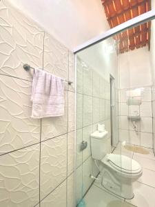 a bathroom with a toilet and a glass shower at Pousada Ondas do Vento in Tatajuba +90 photos