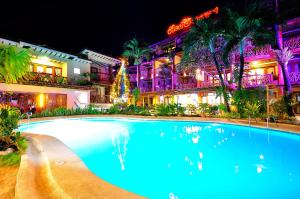a large swimming pool in front of a large building at Red Coconut Beach Hotel Boracay in Boracay