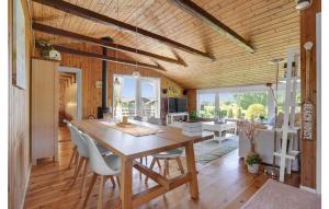 a dining room with a wooden table and chairs at Holiday Home Teglbakken Iv in Egernsund