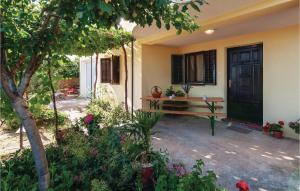 a front porch of a house with a wooden bench at One-Bedroom Apartment In Maslenica in Maslenica