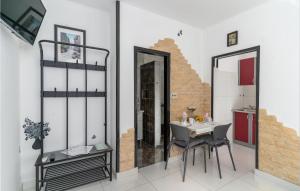 a dining room with a table and two mirrors at 1 Bedroom Stunning Apartment In Krk in Krk