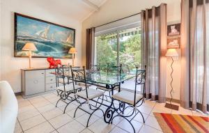 a dining room with a glass table and chairs at Lovely Home In Sainte-Marie-De-Ré in La Flotte