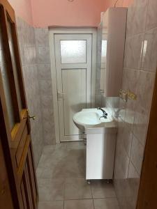 a small bathroom with a sink and a door at Kesen Cappadocia House in Ürgüp