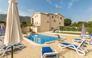 a swimming pool with chairs and an umbrella at Holiday Home Duge Njive With Outdoor Swimming Pool 312 in Duge Njive