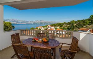 a table with a bowl of fruit on a balcony at Gorgeous Home In Postira in Postira