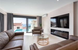 a living room with a couch and a tv at Cozy Home In Makarska in Makarska