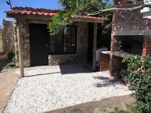 a garage with a door and a brick building at Los Nietos in La Paloma