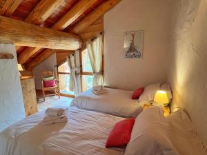 a bedroom with two beds in a room at Le Refuge - 5 bedroom chalet with sauna in Sainte-Foy-Tarentaise
