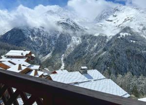 a view of a snow covered mountain from a balcony at Le Refuge - 5 bedroom chalet with sauna in Sainte-Foy-Tarentaise