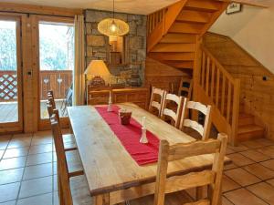 a dining room with a wooden table and stairs at Le Refuge - 5 bedroom chalet with sauna in Sainte-Foy-Tarentaise