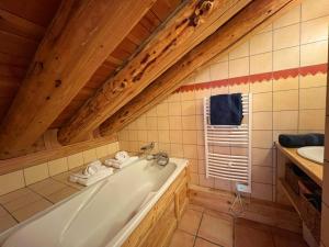 a bathroom with a tub and a sink at Le Refuge - 5 bedroom chalet with sauna in Sainte-Foy-Tarentaise +11 photos
