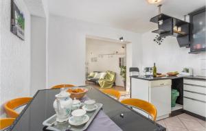 a kitchen and dining room with a table and chairs at Cozy Apartment In Vrbnik With Wifi in Vrbnik