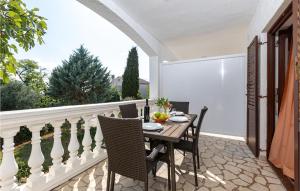 a patio with a table and chairs on a balcony at 1 Bedroom Amazing Apartment In Krk in Krk +16 photos